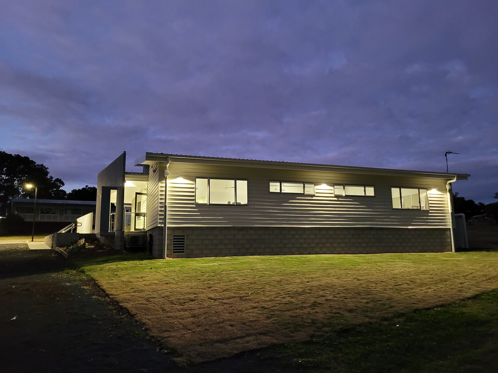 Exterior of a Gowrie State School classroom block. It is night and the building is lit from inside.